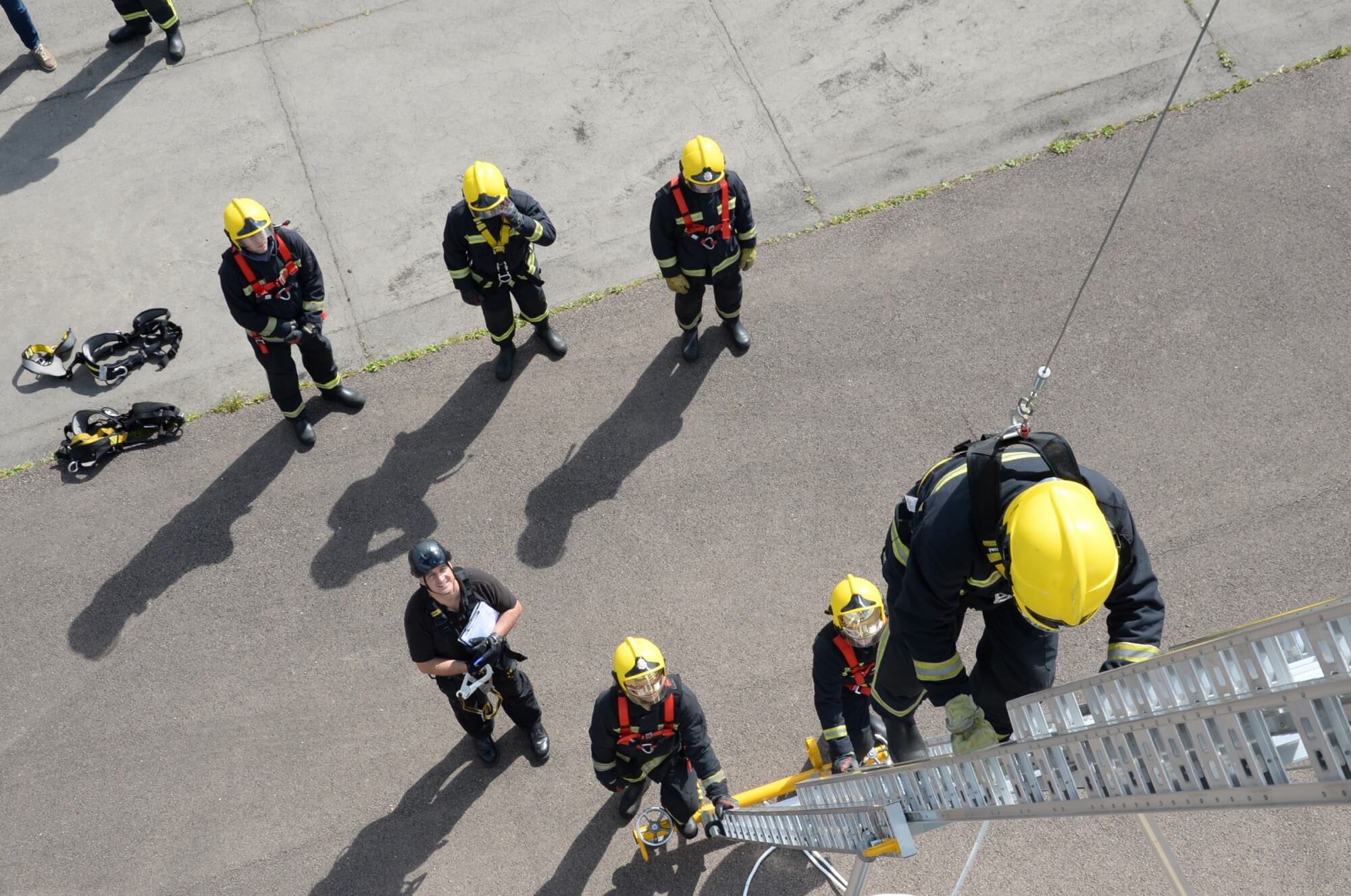 Harness training group with trainee up a ladder