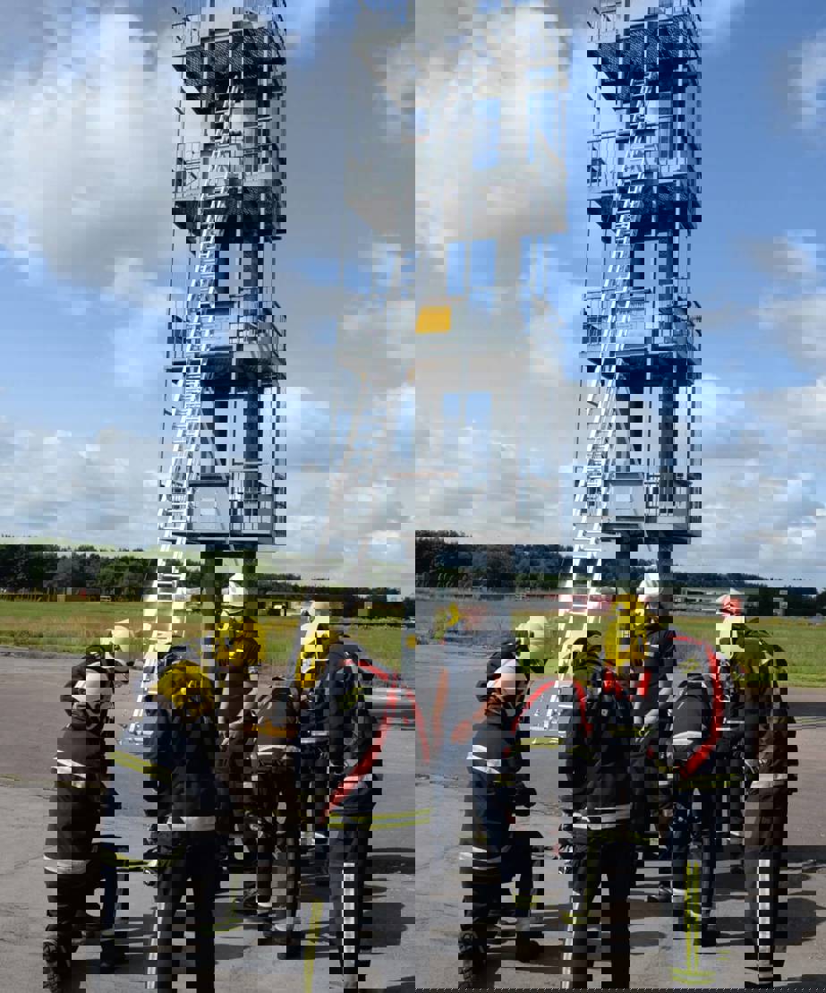 Firefighter trainees in front of training tower