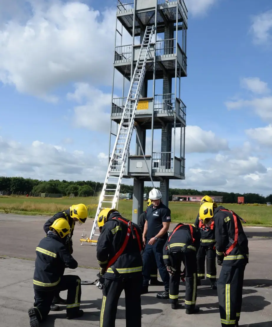 Firefighter trainees in front of training tower