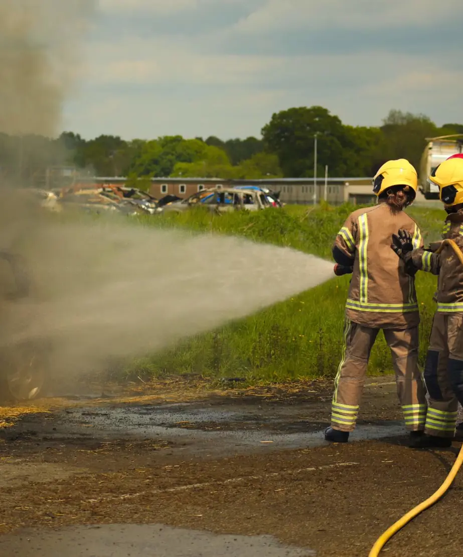 Delegates dousing smoking car with fire hose
