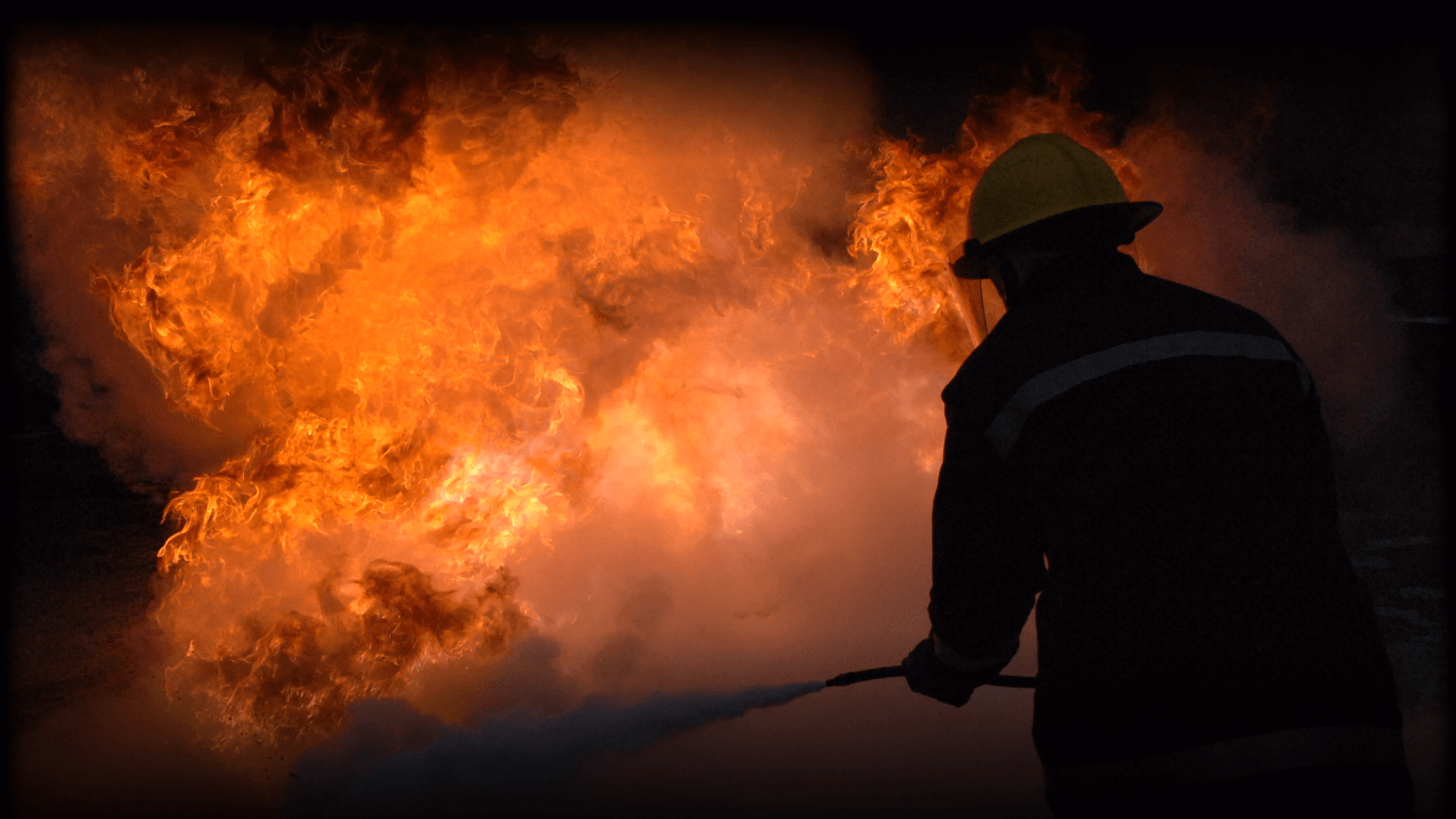 Firefighter dousing fire