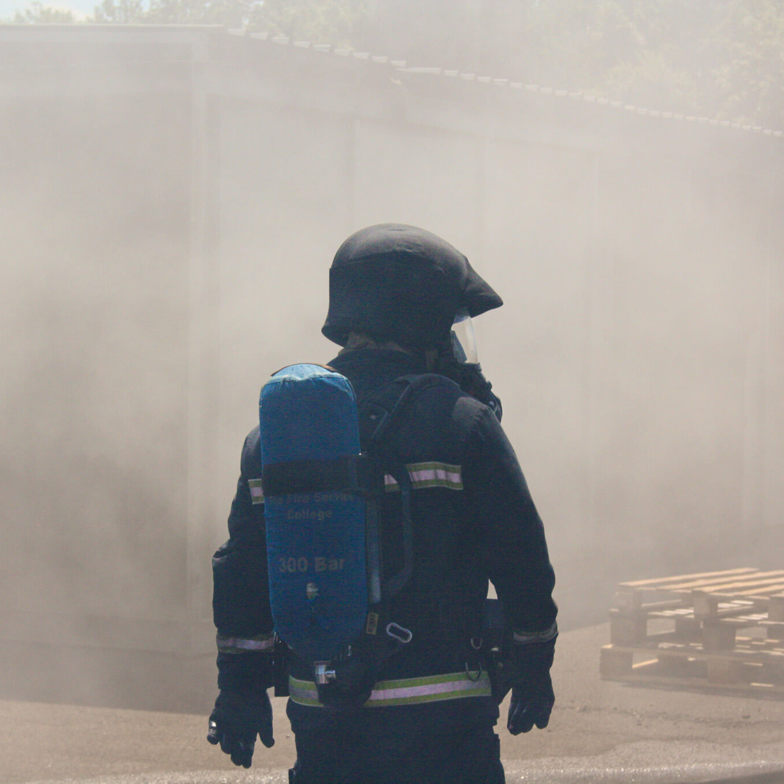 Firefighter training scenario with firefighter with oxygen tank