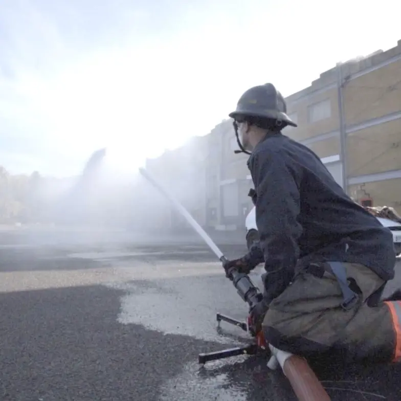 Firefighter training with water hose