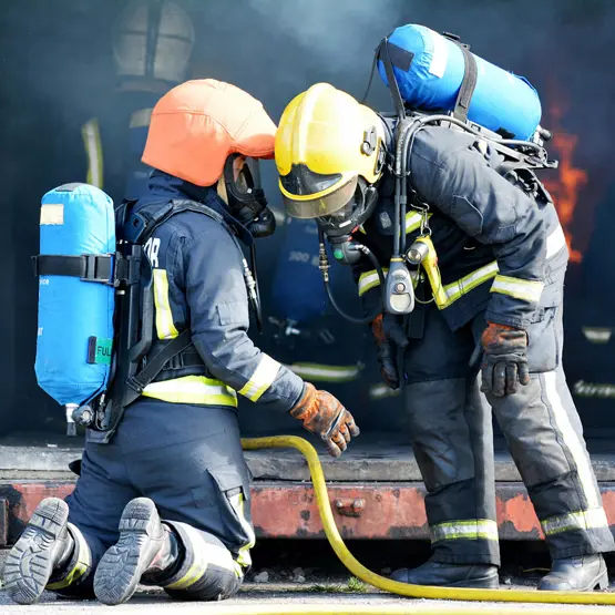 Trainee firefighters with oxygen tanks