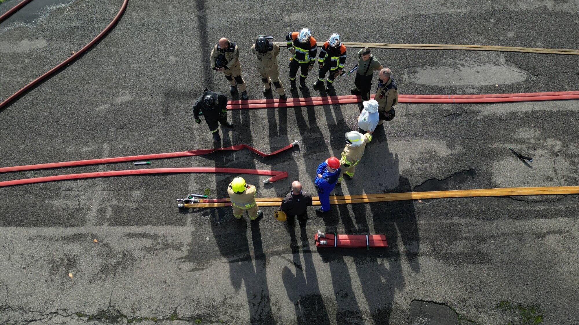 Firefighter training group dousing flames duotone