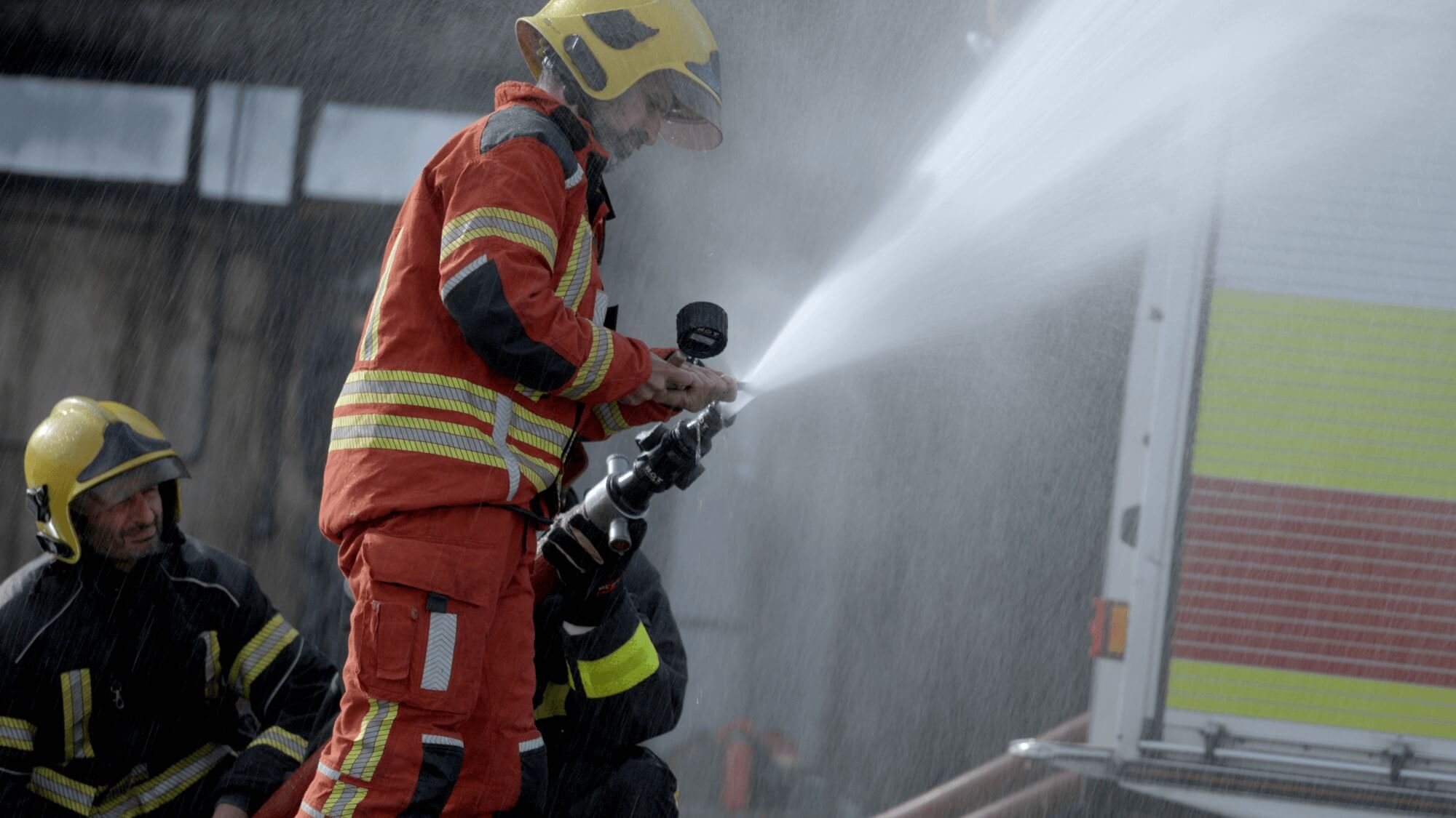 Firefighter training group dousing flames duotone