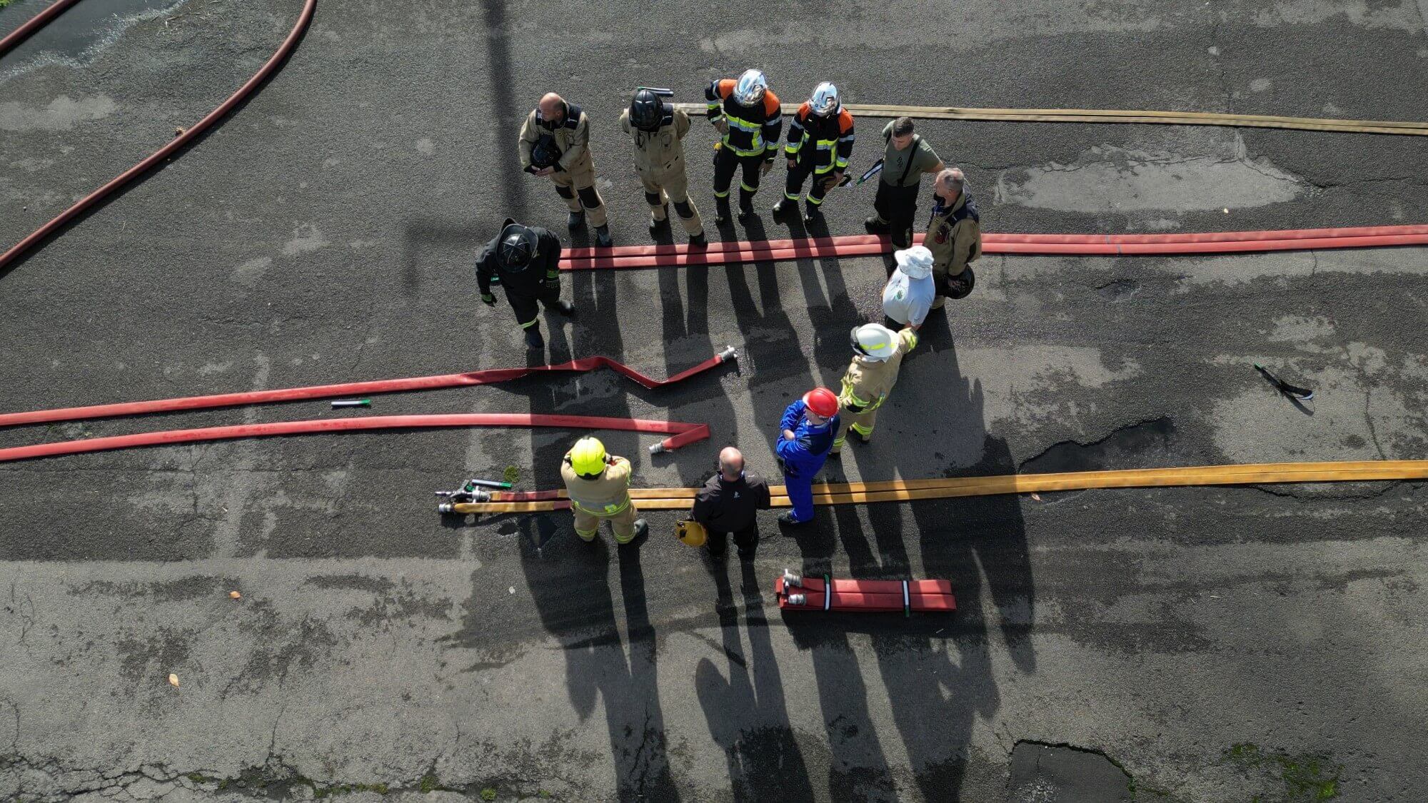 Firefighter fire hose training group aerial view